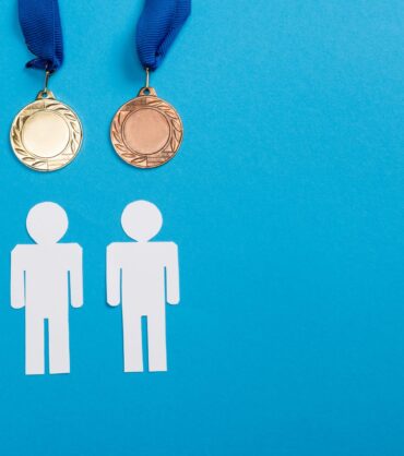 top-view-of-white-paper-cut-people-near-silver-and-2024-11-13-17-06-58-utc